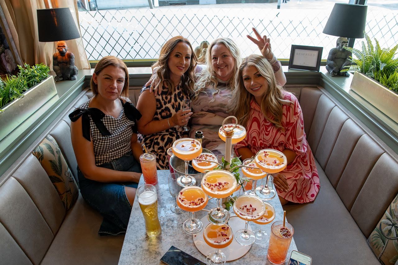A brunch table full of drinks and smiles