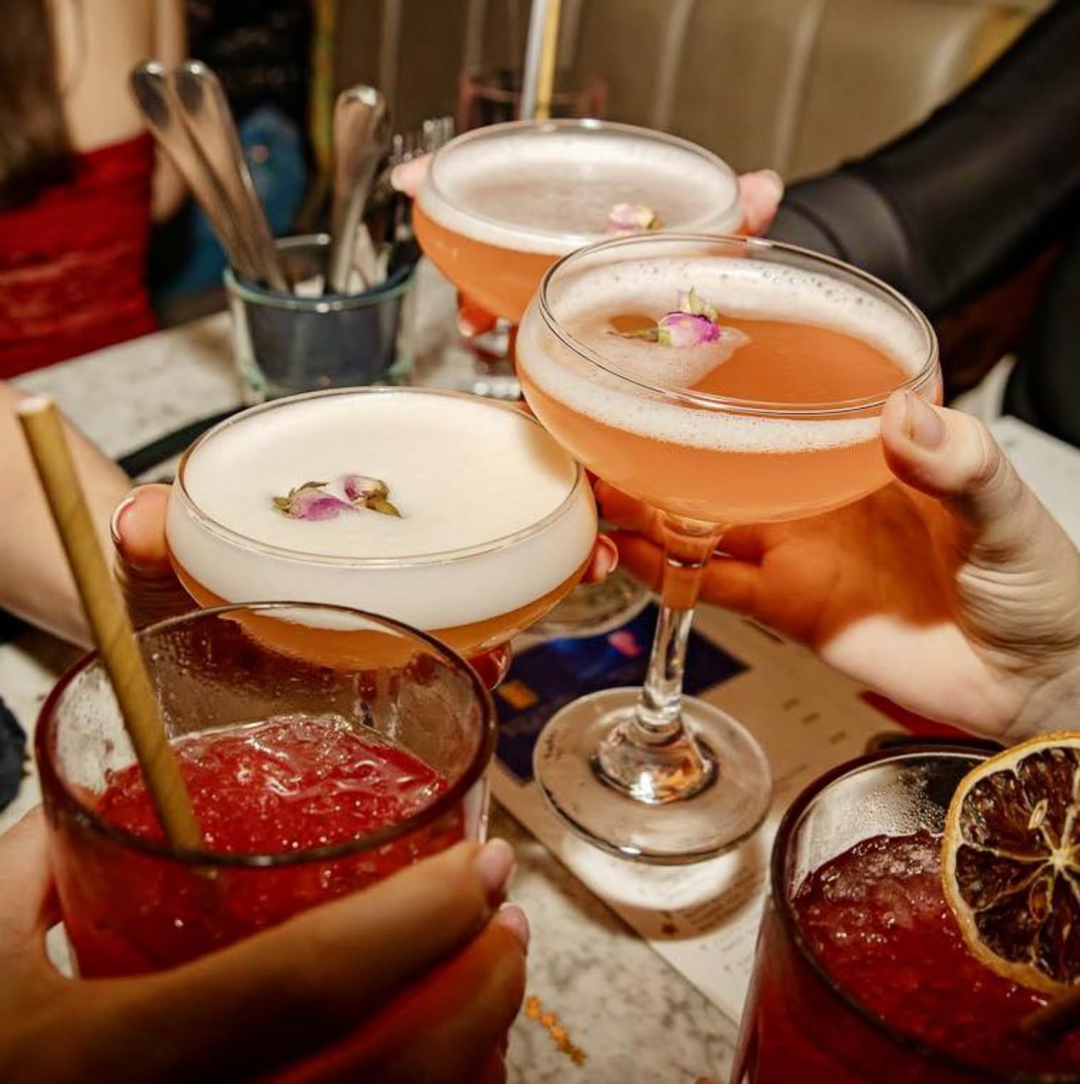 Cocktails clinking over the table