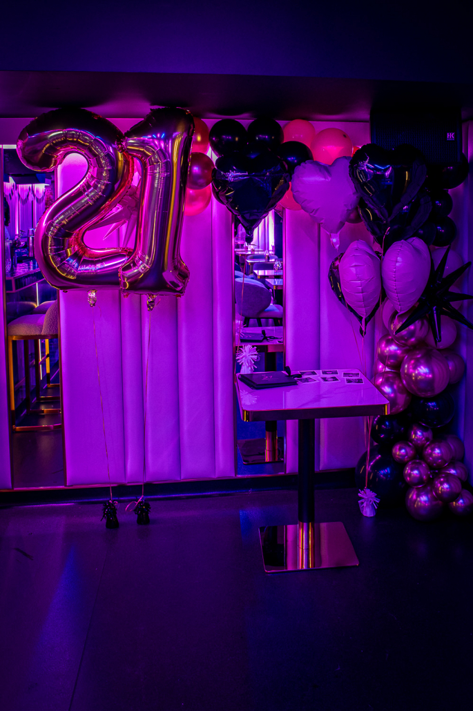 Gold 21 balloons and a balloon arch for a birthday
