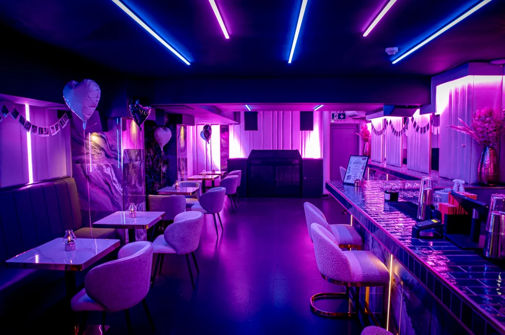 The VIP Room dressed for a party beneath blue neon