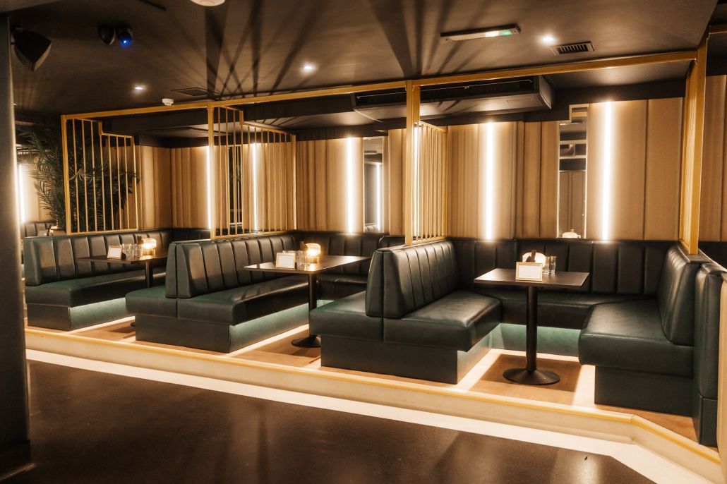 Rows of VIP booths in green leather and gold