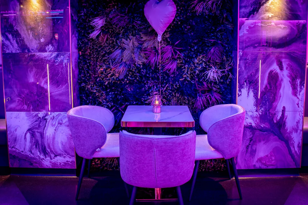 A table for four against the VIP Room's living wall