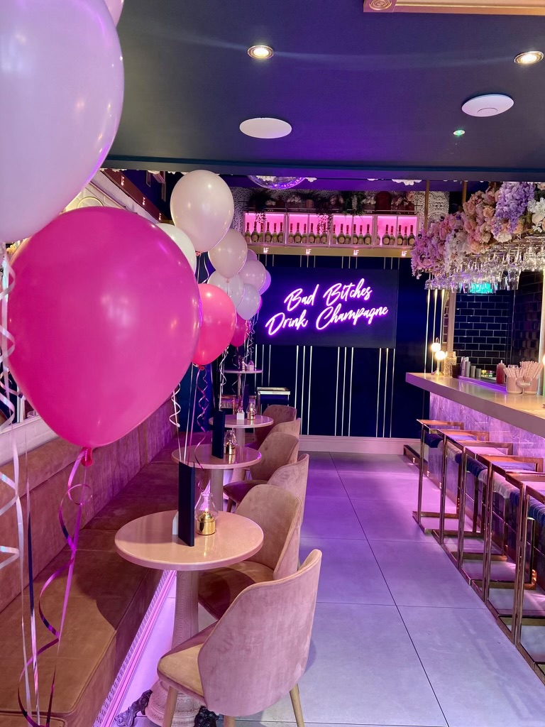 Pink and white balloons among Le Fleur's plush seating